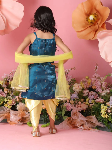 Person wearing a blue dress with yellow dupatta against a pink floral background