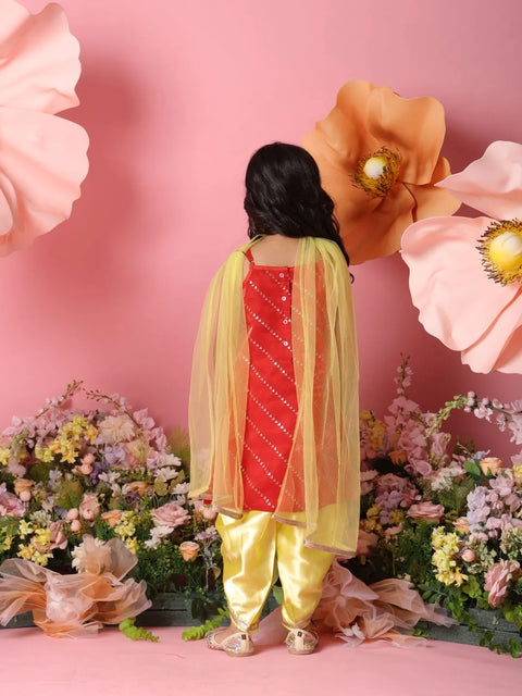 Person wearing a traditional outfit with a pink floral background