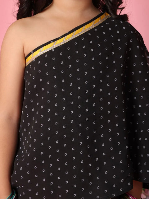 Black patterned dress with yellow trim on a pink background
