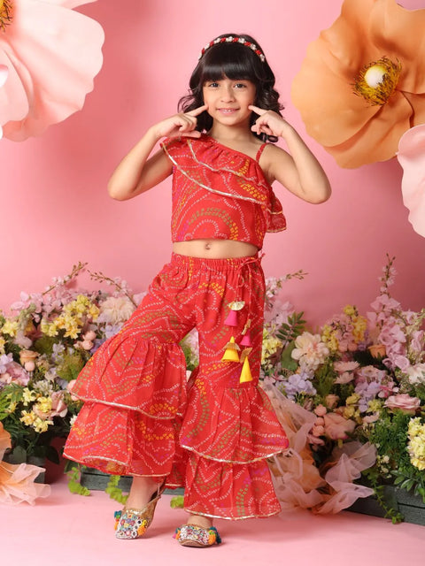 Young girl in a red traditional outfit with flowers and pink background