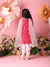 Child wearing a pink traditional outfit with a white dupatta against a pink floral background