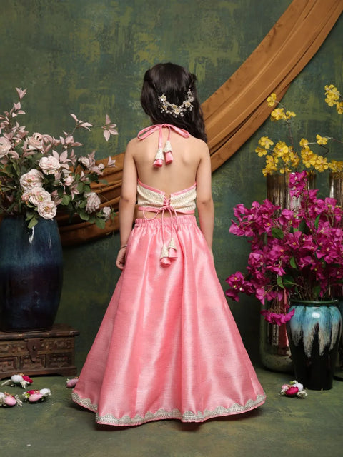 Woman in a pink dress standing in front of floral decorations