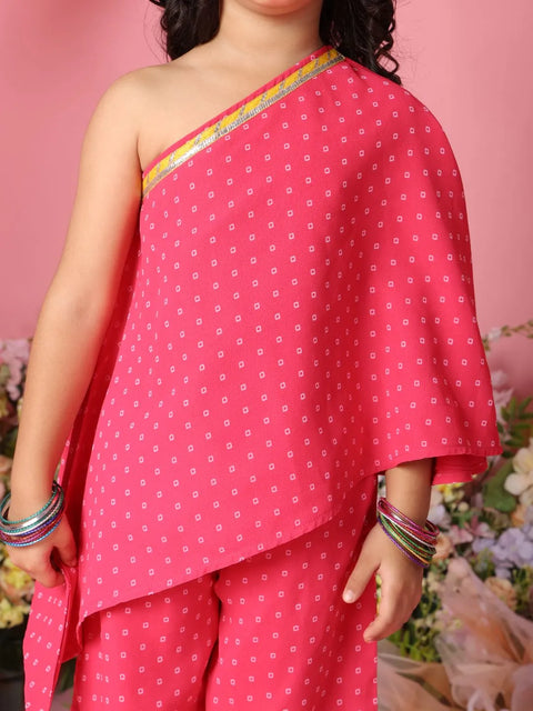 Person wearing a pink traditional outfit with white patterns on a floral background