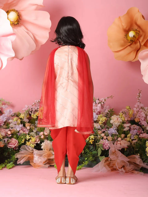 Person wearing a red and white traditional outfit with a pink floral background