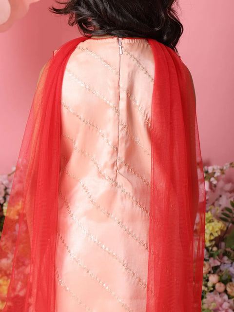 Person wearing a traditional outfit with a red dupatta against a floral and pink background