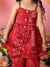 Red traditional outfit with floral patterns on a pink background