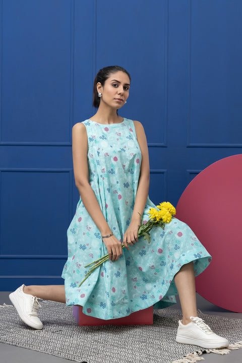 Woman in a light blue floral dress holding yellow flowers against a blue and pink background