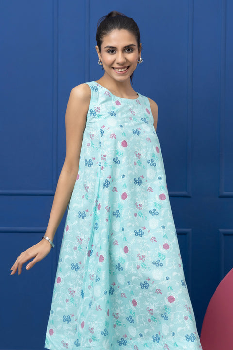 Woman wearing a light blue floral dress against a blue background