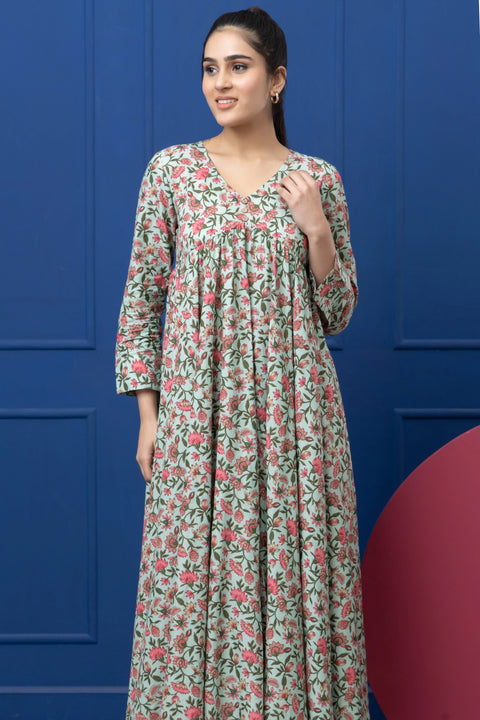 Woman wearing a floral dress against a blue background