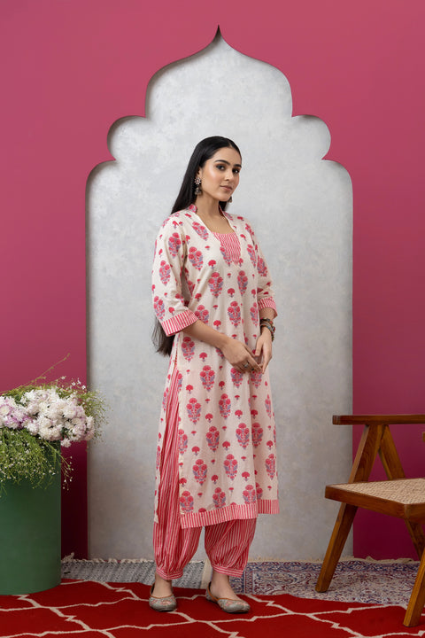 Woman wearing a floral kurta with a pink background