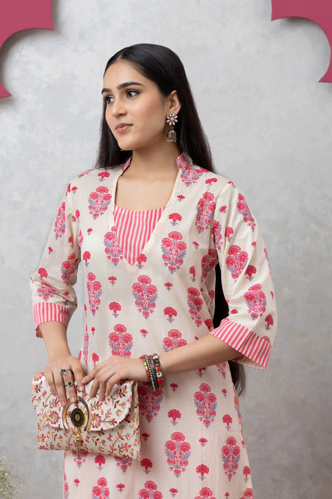 Woman wearing a floral outfit with a pink background