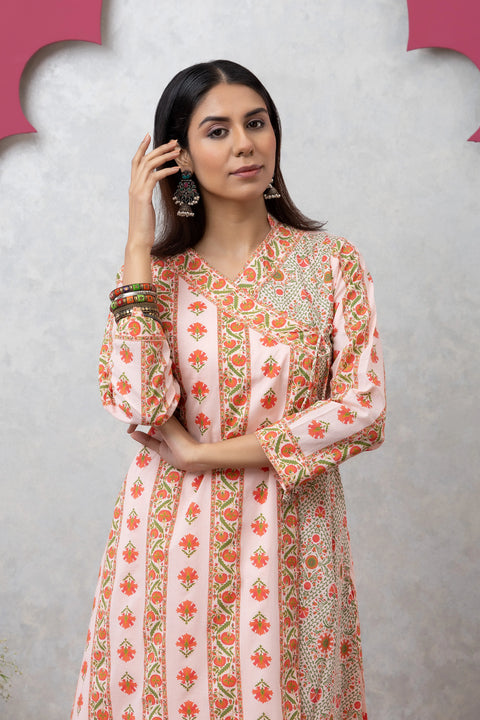 Woman wearing a floral dress against a light gray background