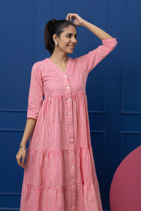 Woman wearing a red and white striped dress against a blue background