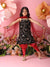 Young girl in a black floral top and red pants posing against a floral and pink background