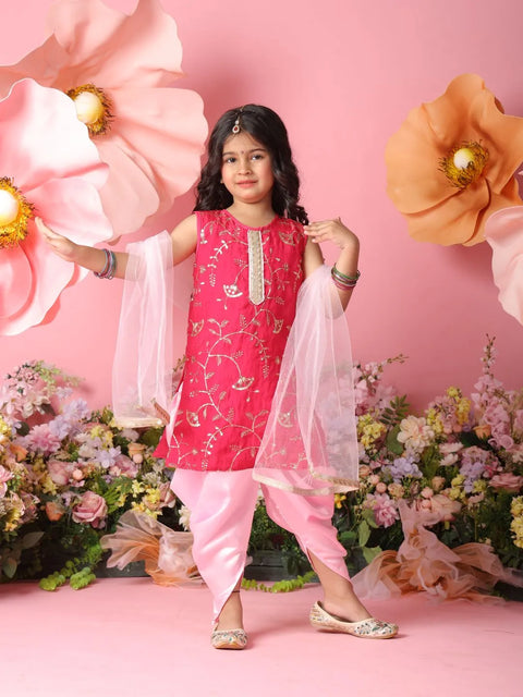 Young girl in a pink traditional outfit with flowers and decorations in the background
