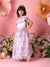 Young girl in a purple floral dress standing in front of a pink background with flowers.
