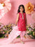Young girl in a red traditional outfit with floral decorations and flowers in the background