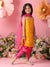 Young girl in a yellow and pink traditional outfit standing against a pink background with flowers.
