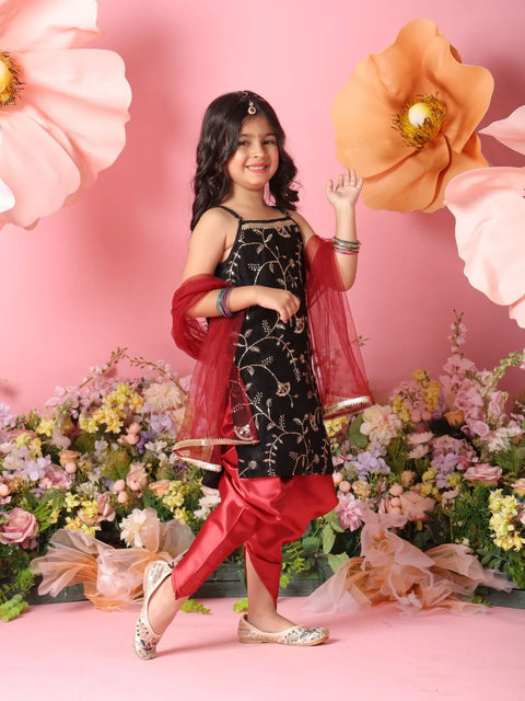 Young girl in traditional outfit with floral decorations and pink background