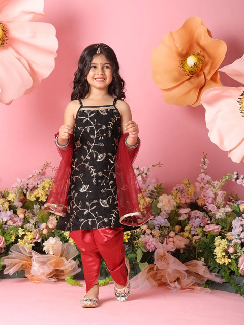 Young girl in traditional outfit with floral and pink background