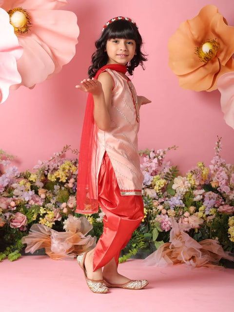 Young girl in traditional outfit with floral decorations on a pink background