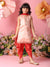 Young girl in traditional pink and red outfit with floral decorations on a pink background